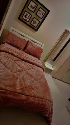 a bedroom with a bed with red pillows on it at شقه مفروشه للإيجار مكونه من 4 غرف في عمان in Amman