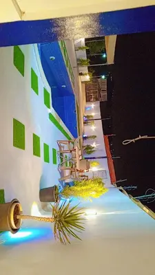 a room with a staircase with green squares on the wall at Happy farm in Umm Jawzah