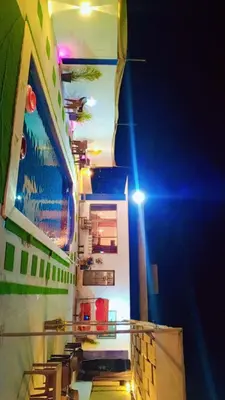 a cruise ship at night with its lights on at Happy farm in Umm Jawzah