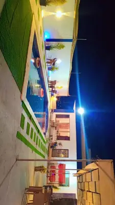a view of a building at night with at Happy farm in Umm Jawzah