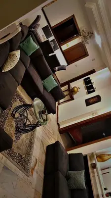 a living room with a bunch of pillows on the wall at شقه مفروشه بالكامل في عمان شارع مكه ضاحيه الأمير راشد in Amman