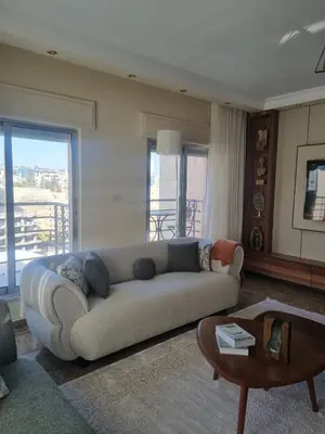 a living room with a couch and a table at Elegant 2 bedrooms in 4th circle-Diplomatic Area in Amman
