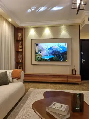 a living room with a large flat screen tv on a wall at Elegant 2 bedrooms in 4th circle-Diplomatic Area in Amman