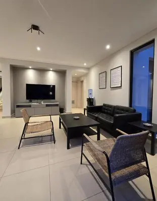 a living room with a couch and a table at RV Villas Deadsea in Sowayma