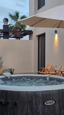 a hot tub in the backyard of a house at RV Villas Deadsea in Sowayma