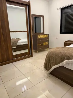 a bedroom with a bed and a large mirror at Rooftop sport city in Amman