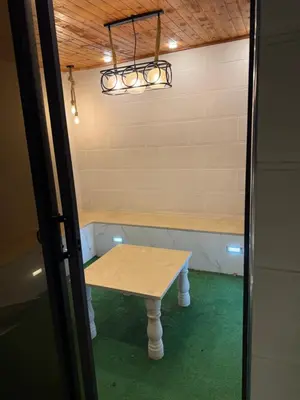 a small table in a room with a table in it at Rooftop sport city in Amman