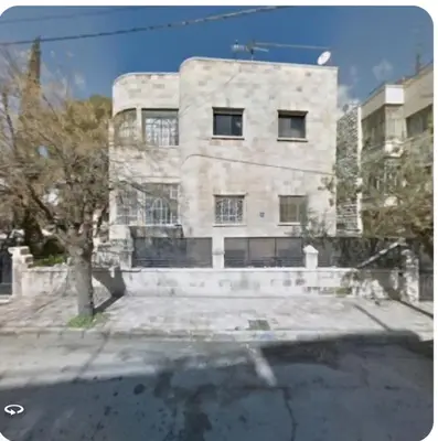 a stone building with a tree in front of it at Cozy Studio 1 Central Amman Near Rainbow Street in Amman