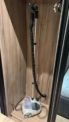 a phone plugged into a wall with a cord at Cozy Modern Apartment Damac Abdali in Amman
