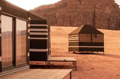 a tent and a bench in the desert at Wadi Rum Bedoun in Wadi Rum