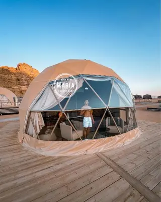 a man is standing inside of a tent at MARIA LUXURY CAMp&BUBBLES ROOM in Wadi Rum