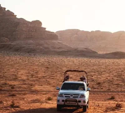 a white truck parked in the middle of the desert at Oasis of Wonders Camp in Wadi Rum