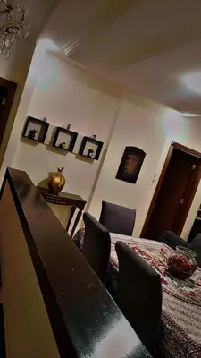 a bedroom with a bed and a table with chairs at ضاحيه الأمير راشد in Amman