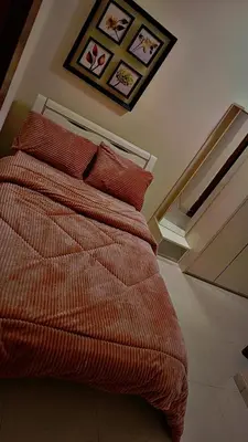 a bed with orange sheets and pillows in a room at ضاحيه الأمير راشد in Amman