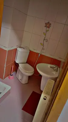 a bathroom with a toilet and a sink at ضاحيه الأمير راشد in Amman