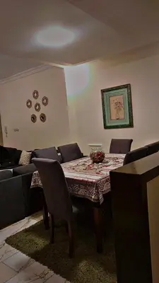 a dining room with a table and a couch at ضاحيه الأمير راشد in Amman