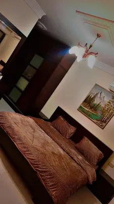 a bedroom with a bed and a picture on the wall at ضاحيه الأمير راشد in Amman