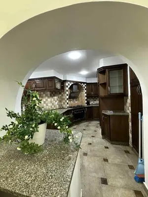 a kitchen with an archway in the middle of it at Amman Jordan جبل عمان الدوار الاول in Ash Shumaysānī