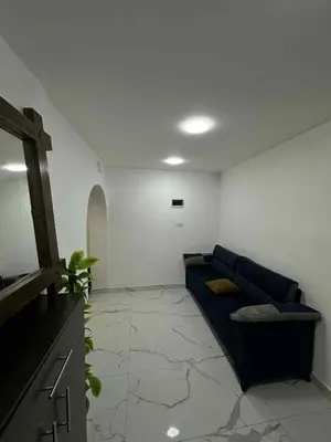 a living room with a blue couch in a room at Amman Jordan جبل عمان الدوار الاول in Ash Shumaysānī