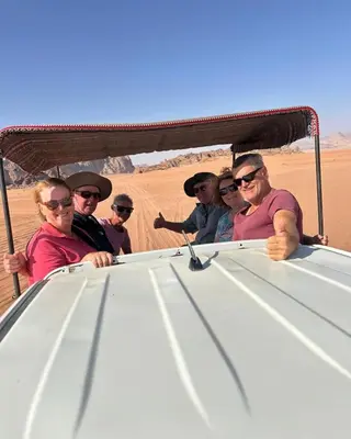 a group of people in a jeep in the desert at Jeep trips in the desert in Wadi Rum