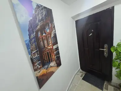 a painting of a building on a wall next to a door at Cozy Studio 2 Central Amman, Near Rainbow Street in Amman