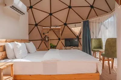 a bedroom with a large bed in a yurt at Magic rum luxury camp in Wadi Rum