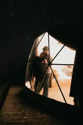 a man standing inside of a glass window at Magic rum luxury camp in Wadi Rum