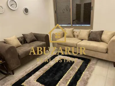 a living room with a couch and a rug at Furnished apartment in Abdoun in Amman