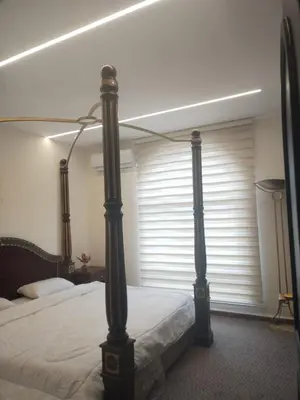 a bedroom with a canopy bed with a window at Power Stay Hotel in Amman