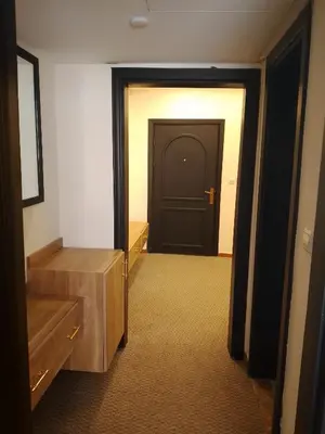 a hallway with a black door in a room at Power Stay Hotel in Amman