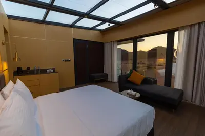 a hotel room with a bed and a couch at Rum Reserve Resort-By Luxotel in Wadi Rum