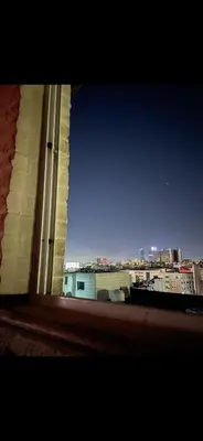 a window with a view of a city skyline at Rabieh Rose in Amman