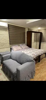 a room with two beds and a couch in it at Rabieh Rose in Amman