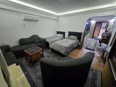 a living room with two couches and a couch at Studio 3 Cozy Amman Central Near Rainbow Street & First Circle in Amman