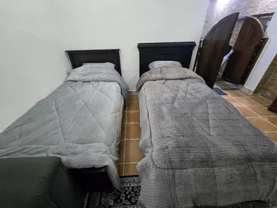 two beds sitting next to each other in a room at Studio 3 Cozy Amman Central Near Rainbow Street & First Circle in Amman