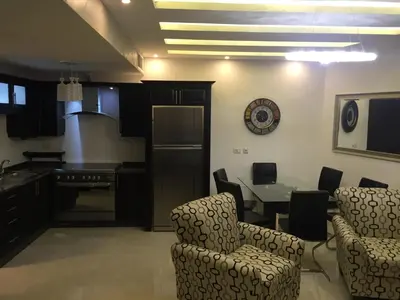 a kitchen and dining room with a table and chairs at شقة مفروشة للإيجار بالرابية بالقرب من السفارة الصينية in Amman
