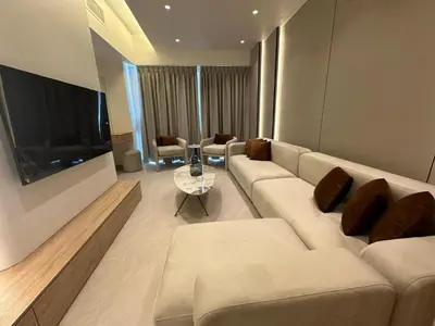 a living room with a couch and a tv at Damac Amman Modern Luxury Apartment in Amman