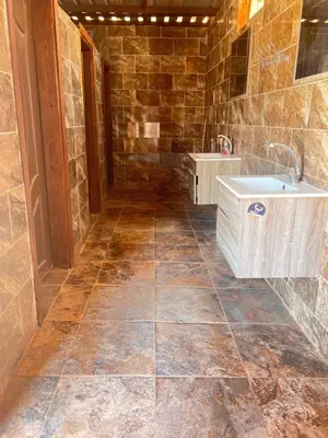 a bathroom with a sink and a tile floor at Wadi Rum Bedouin in Wadi Rum