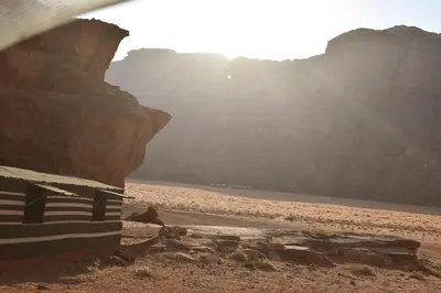 a view of a beach with a rocky cliff at Nature rum camp in Wadi Rum