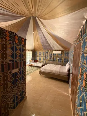 a bedroom with a bed in a tent at Wadi Rum Al-Hadi camp in Disah