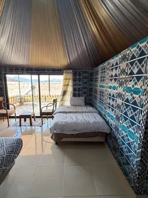 a bedroom with a bed in a tent at Wadi Rum Al-Hadi camp in Disah