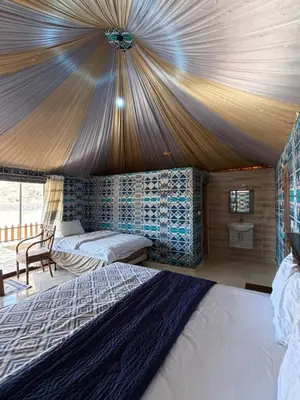 a bedroom with two beds in a tent at Wadi Rum Al-Hadi camp in Disah
