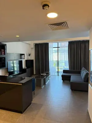 a large living room with a couch and a table at DAMAC AMMAN LUXURY APARTMENTs داماك عمان شقق فاخرة in Amman