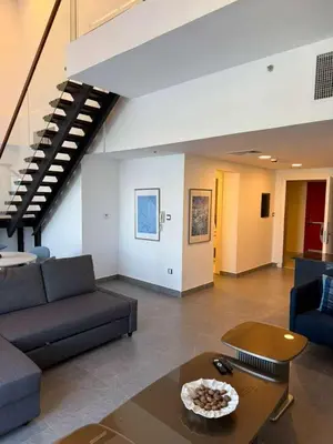 a living room with a couch and a table at DAMAC AMMAN LUXURY APARTMENTs داماك عمان شقق فاخرة in Amman