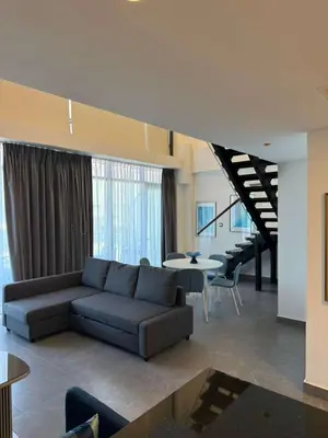 a living room with a couch and chairs and tables at DAMAC AMMAN LUXURY APARTMENTs داماك عمان شقق فاخرة in Amman