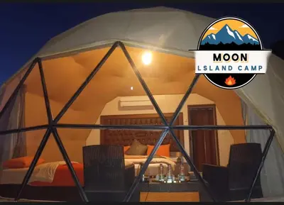 a dome tent with a bed and a sign that reads moon island camp at MOON ISLAND lUXURY CAMP in Wadi Rum