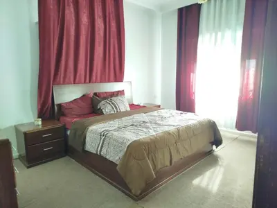 a bedroom with a bed and a dresser and a window at طبربور in Amman