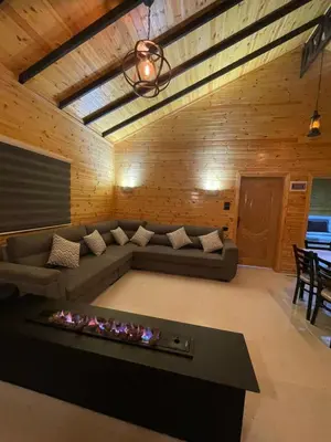 a living room with a couch and a fire place at شاليه غصن in Ajloun