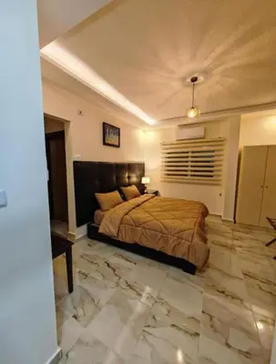 a bedroom with a large bed and a stone floor at I cloud Petra hostel in Wadi Musa