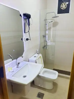 a bathroom with a sink and a toilet and a shower at I cloud Petra hostel in Wadi Musa
